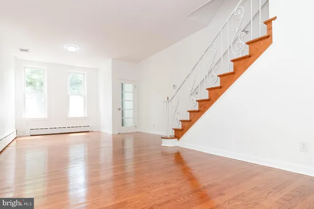 a view of an entryway with wooden floor