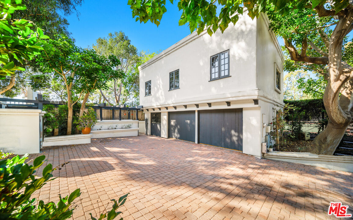 6611 Portshead Road Malibu, CA 90265 - Photo 3 of 19 a front view of a house with a yard and garage