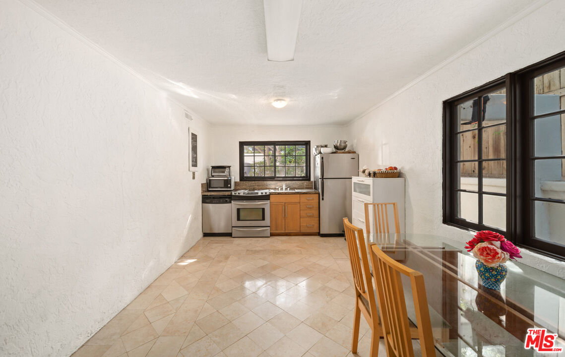 6611 Portshead Road Malibu, CA 90265 - Photo 5 of 19 a kitchen with stainless steel appliances granite countertop a refrigerator and a stove