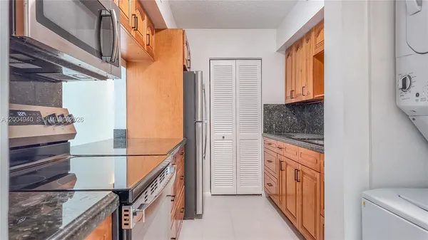 a hallway with washer dryer and cabinets