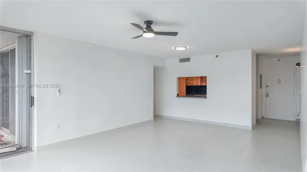 an empty room with closet and windows