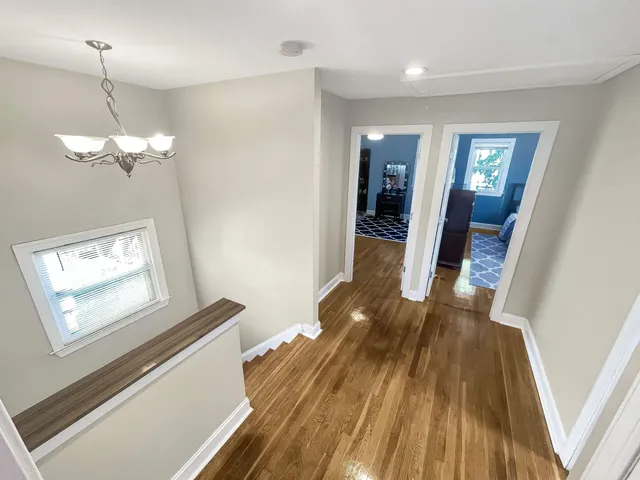 a view of a hallway view with wooden floor and staircase