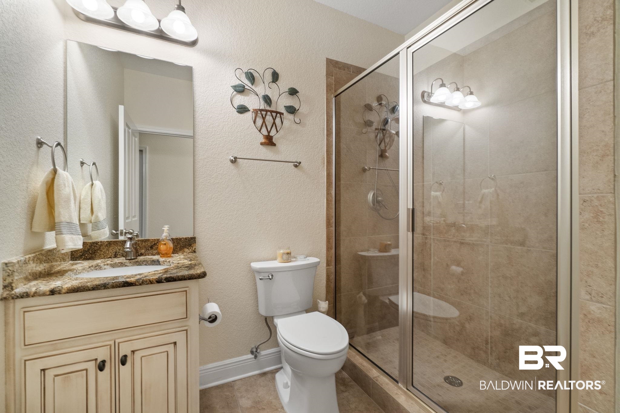 8664 Foxtail Loop Pensacola, FL 32526 - Photo 41 of 64 Full bathroom with a shower stall, toilet, vanity, and tile patterned floors