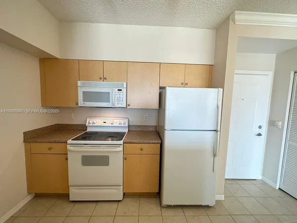 a white refrigerator freezer sitting in a kitchen