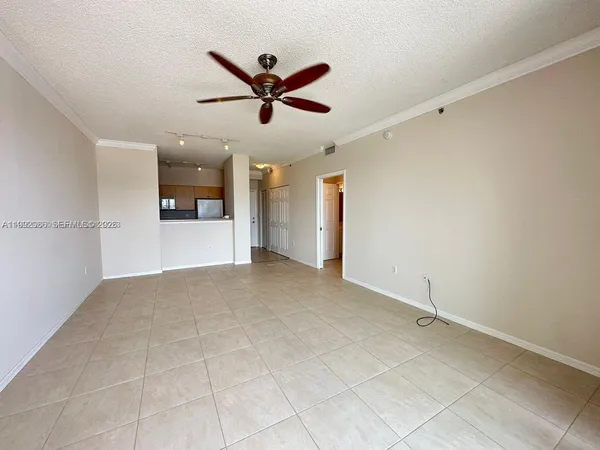 a view of a livingroom with a ceiling fan and window