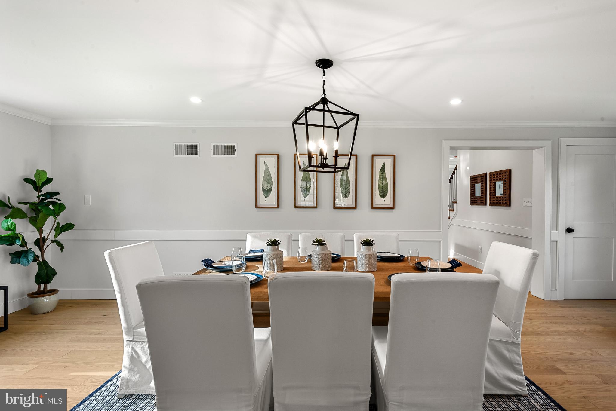 670 Leopard Road Berwyn, PA 19312 - Photo 23 of 52 a dining room with furniture a chandelier and wooden floor