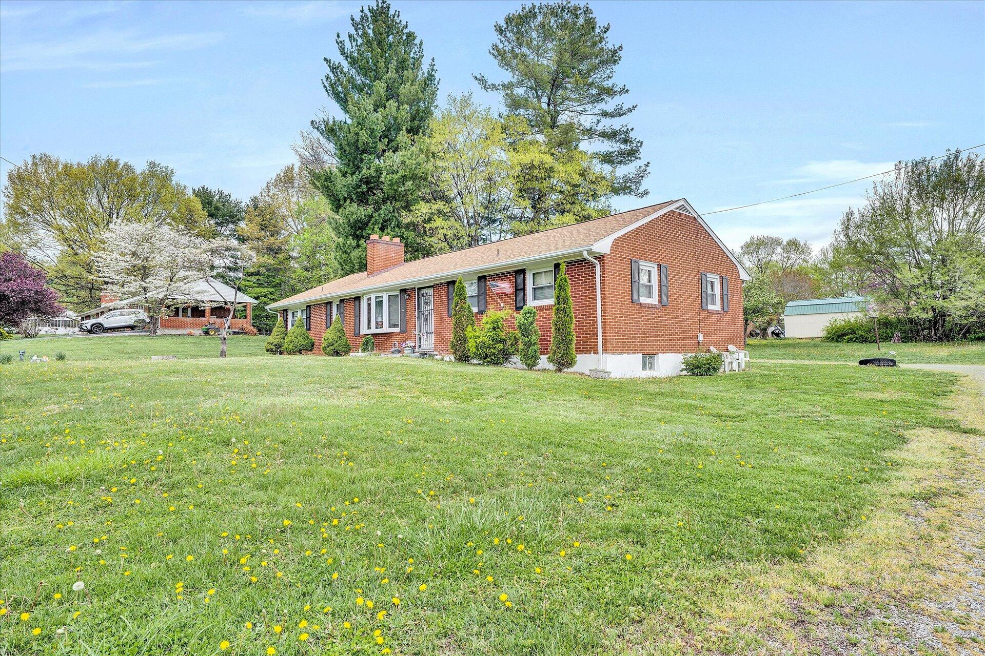 196 Oak Drive Blue Ridge, VA 24064 - Photo 3 of 21 a front view of house with yard and green space