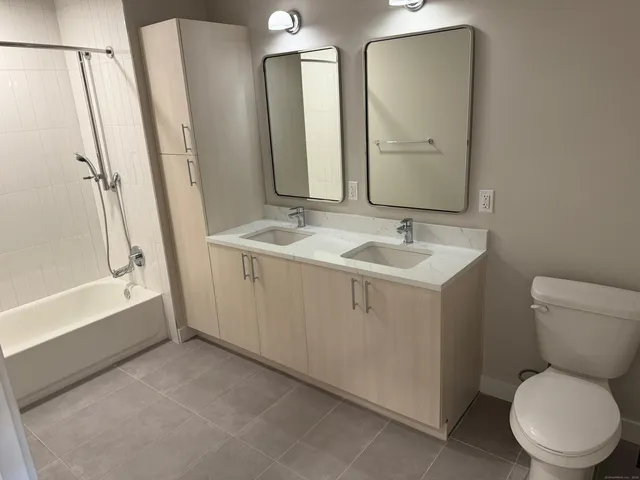 a bathroom with a toilet sink and a mirror