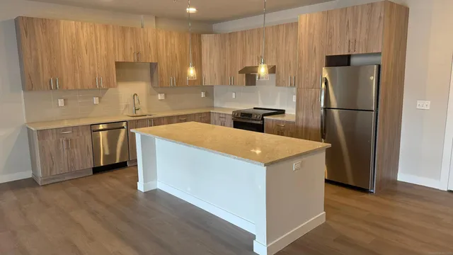 a kitchen with stainless steel appliances a refrigerator and a stove