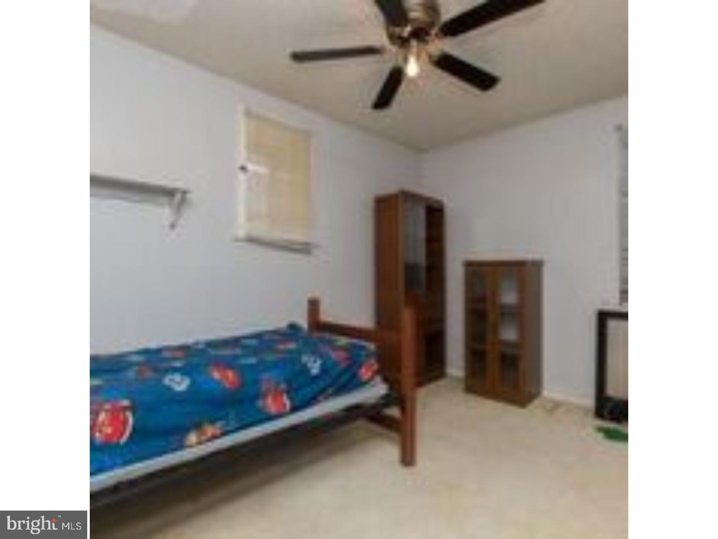 225 Barrington Road Upper Darby, PA 19082 - Photo 12 of 15 a room with a bed and a ceiling fan