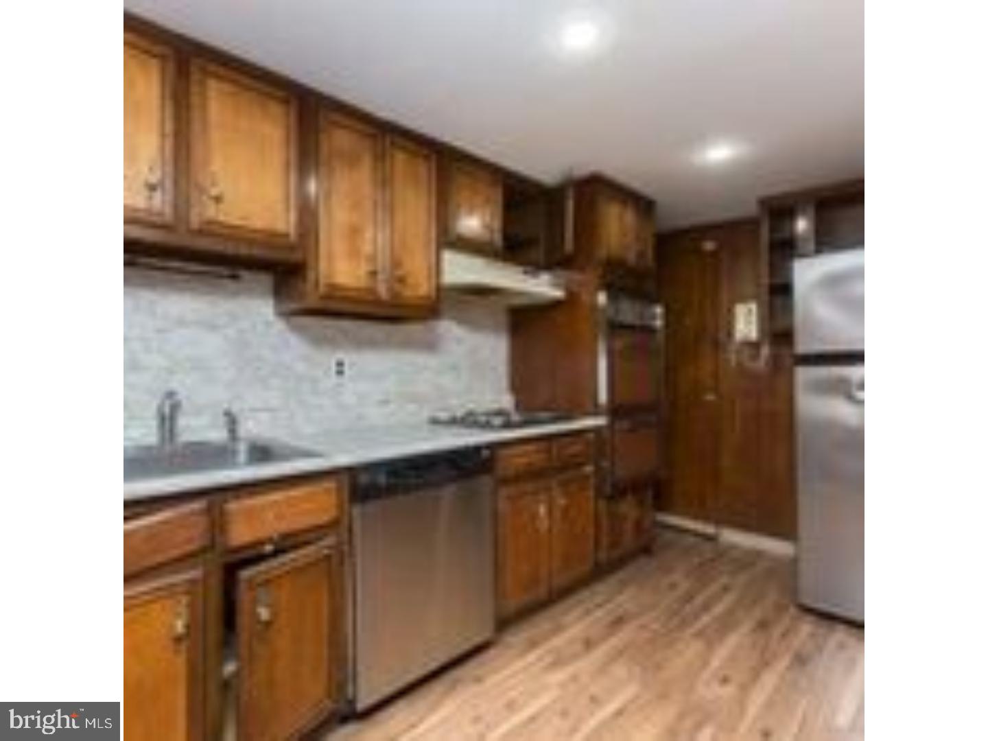 225 Barrington Road Upper Darby, PA 19082 - Photo 7 of 15 a kitchen with stainless steel appliances granite countertop wooden cabinets sink and stove