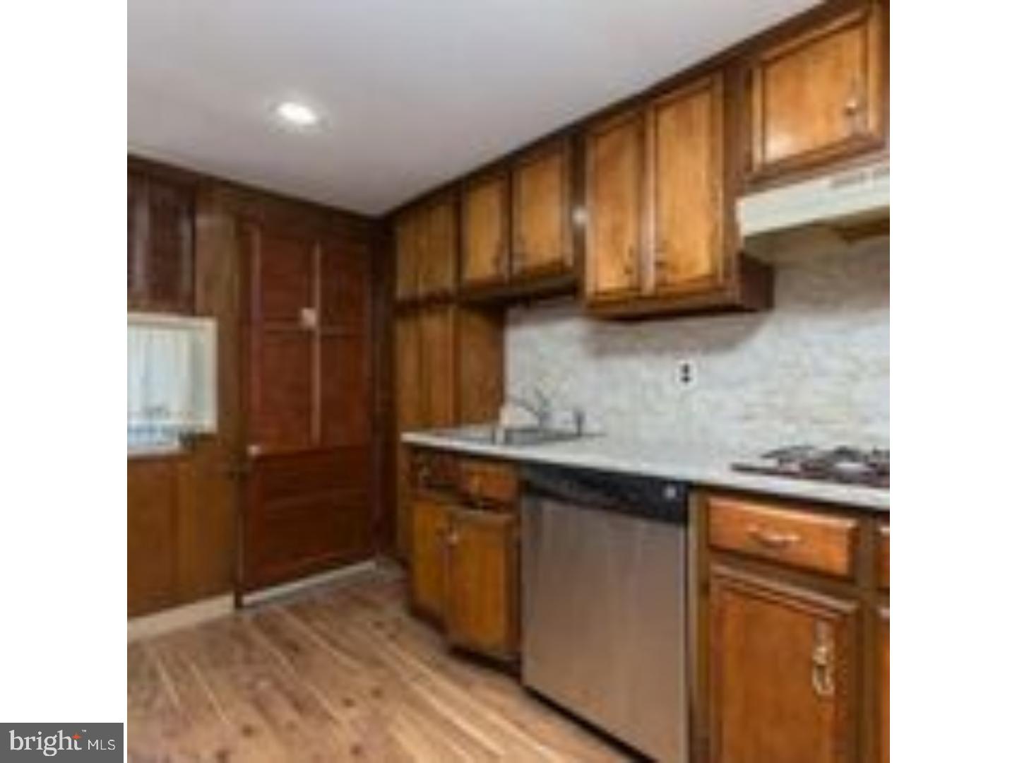 225 Barrington Road Upper Darby, PA 19082 - Photo 8 of 15 a kitchen with stainless steel appliances granite countertop a sink stove and cabinets