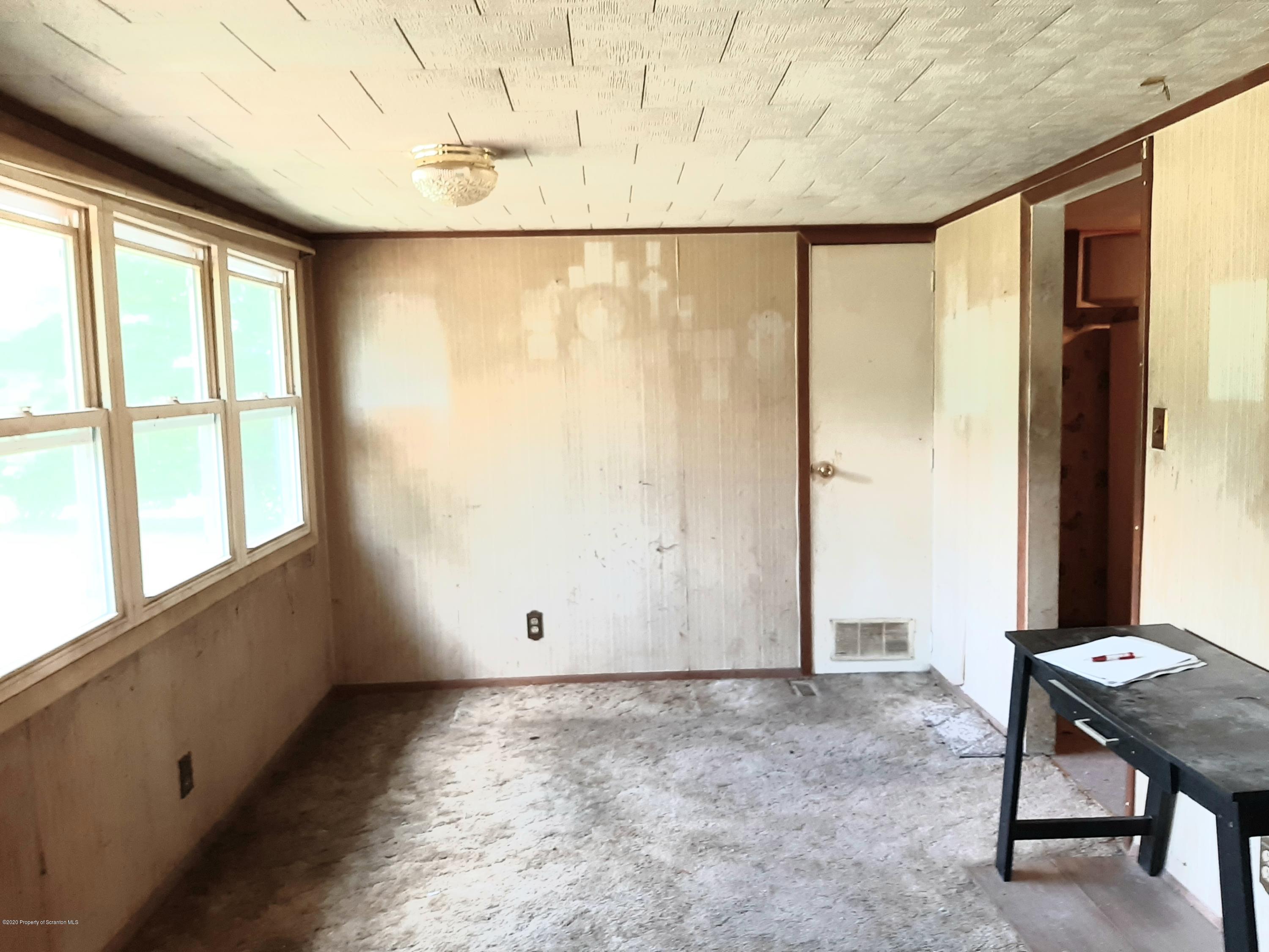 774 Creek Road Nicholson, PA 18446 - Photo 8 of 16 an empty room with windows