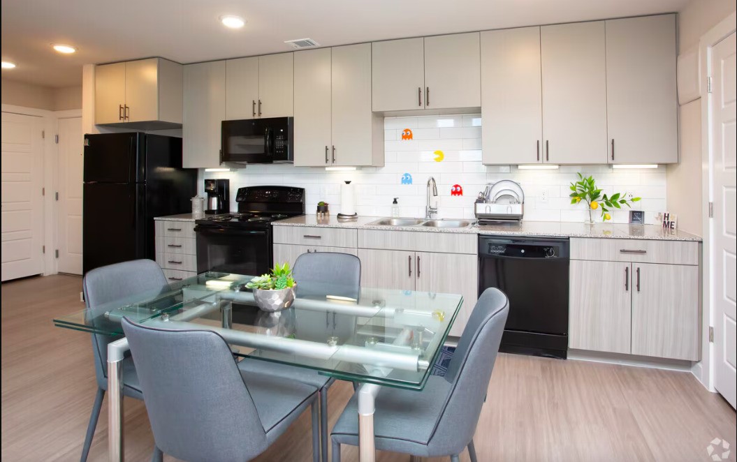 1800 South I- 35 Service Road Austin, TX 78748 - Photo 11 of 21 a kitchen with a table chairs refrigerator and microwave