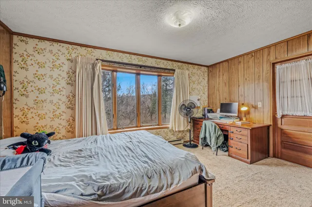 a bed sitting in a room next to a window