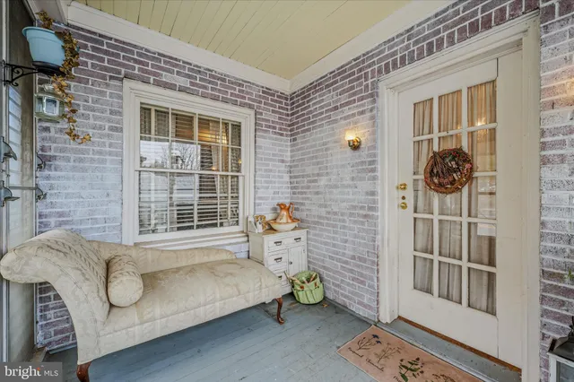 a living room with furniture and next to a window