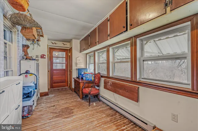 a view of a hallway with wooden floor and entryway