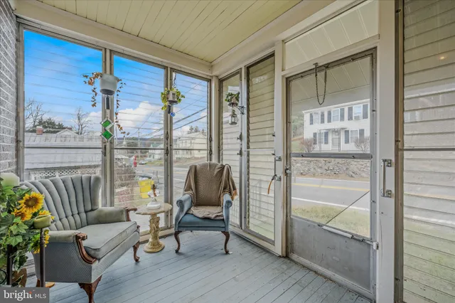 a balcony with furniture and a potted plant