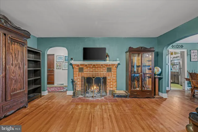 a living room with fireplace furniture and a flat screen tv