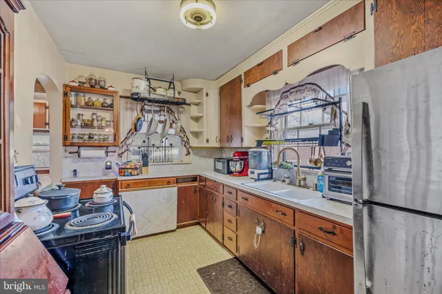 a kitchen with stainless steel appliances granite countertop a sink and cabinets