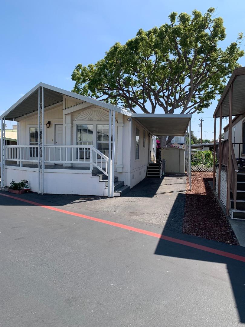 1201 Sycamore Terrace, Unit 87 Sunnyvale, CA 94086 - Photo 1 of 26 a front view of a house with a yard and garage