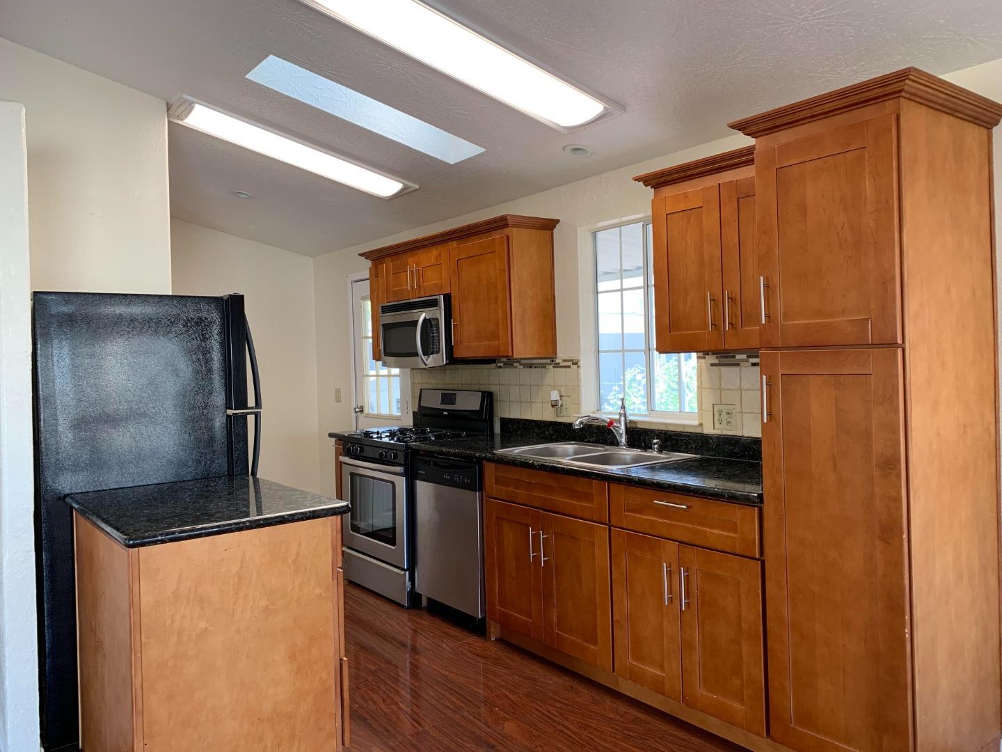 1201 Sycamore Terrace, Unit 87 Sunnyvale, CA 94086 - Photo 12 of 26 a kitchen with granite countertop stainless steel appliances a refrigerator a sink a stove and cabinets
