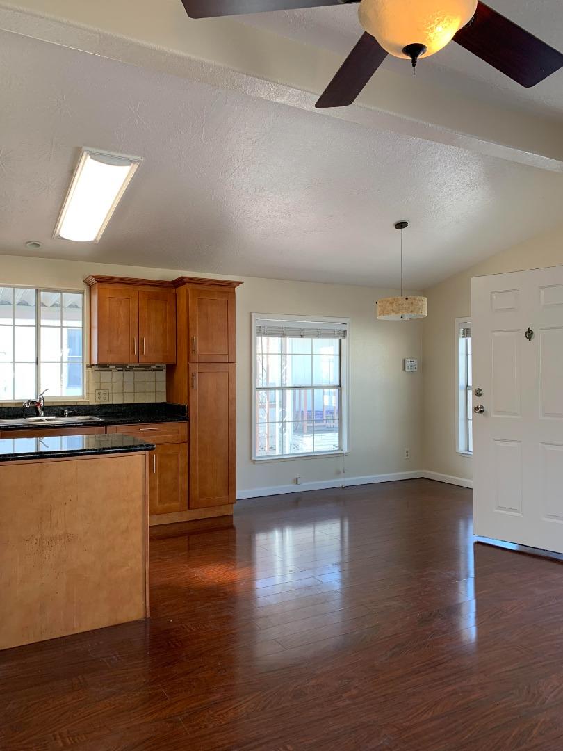 1201 Sycamore Terrace, Unit 87 Sunnyvale, CA 94086 - Photo 13 of 26 an empty room with wooden floor and windows