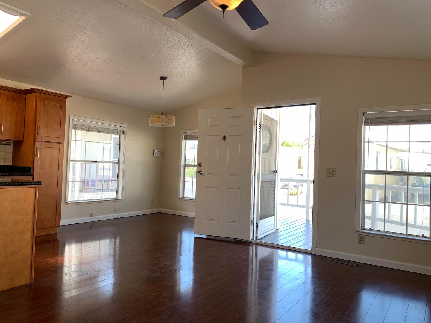 1201 Sycamore Terrace, Unit 87 Sunnyvale, CA 94086 - Photo 17 of 26 an empty room with wooden floor and windows
