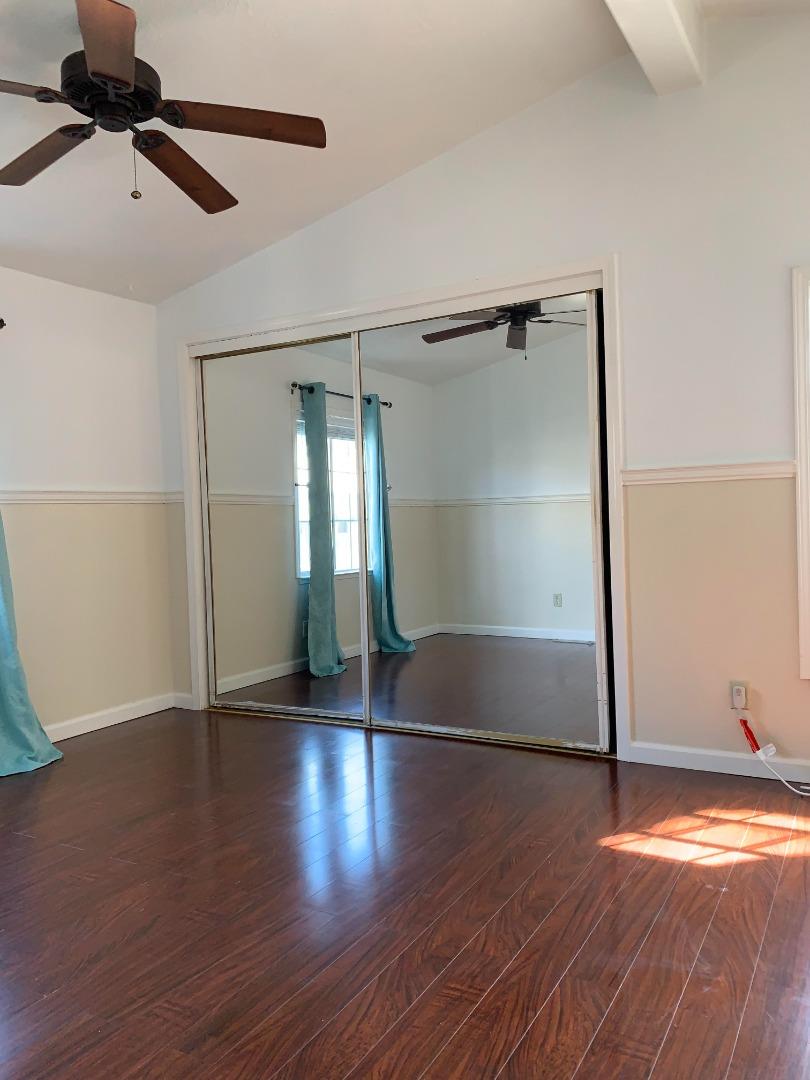 1201 Sycamore Terrace, Unit 87 Sunnyvale, CA 94086 - Photo 18 of 26 an empty room with wooden floor cabinet and windows