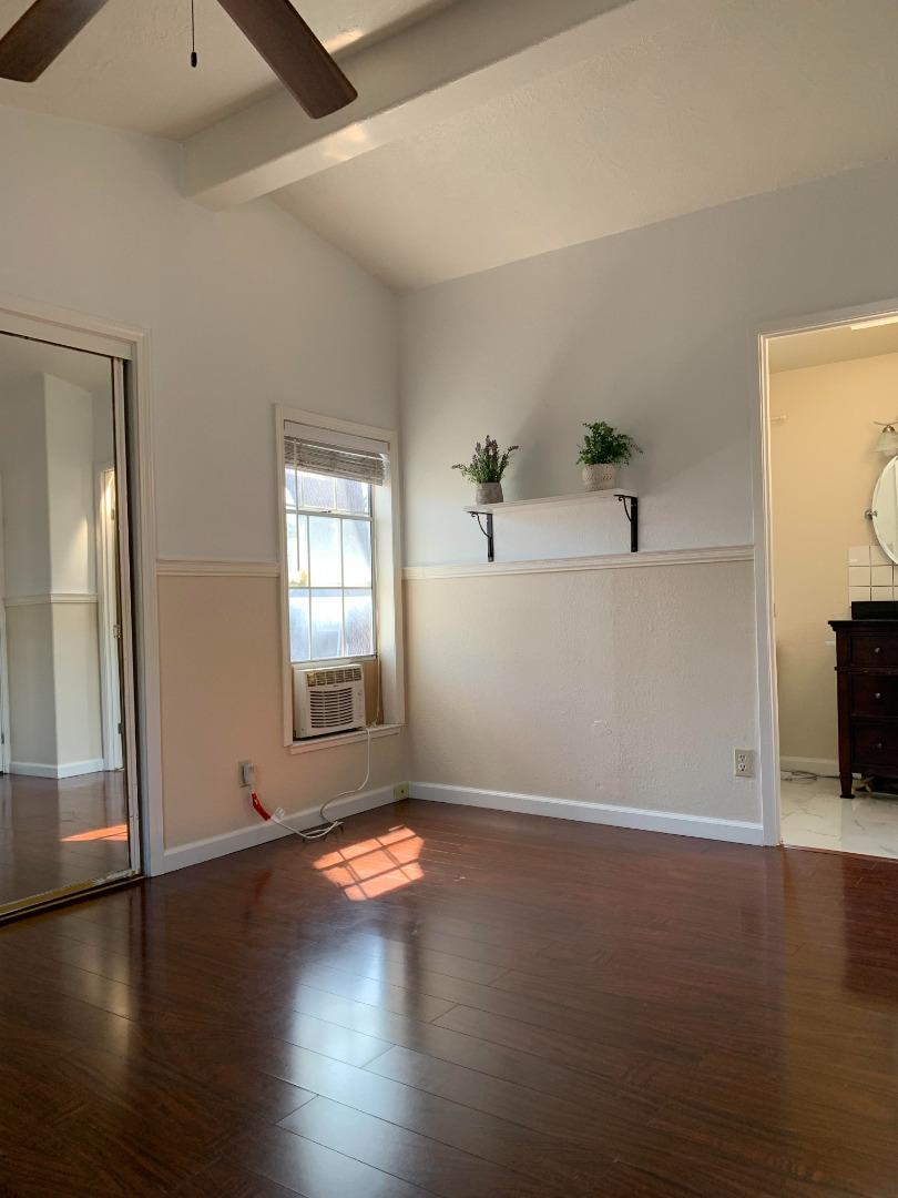 1201 Sycamore Terrace, Unit 87 Sunnyvale, CA 94086 - Photo 21 of 26 an empty room with wooden floor and windows