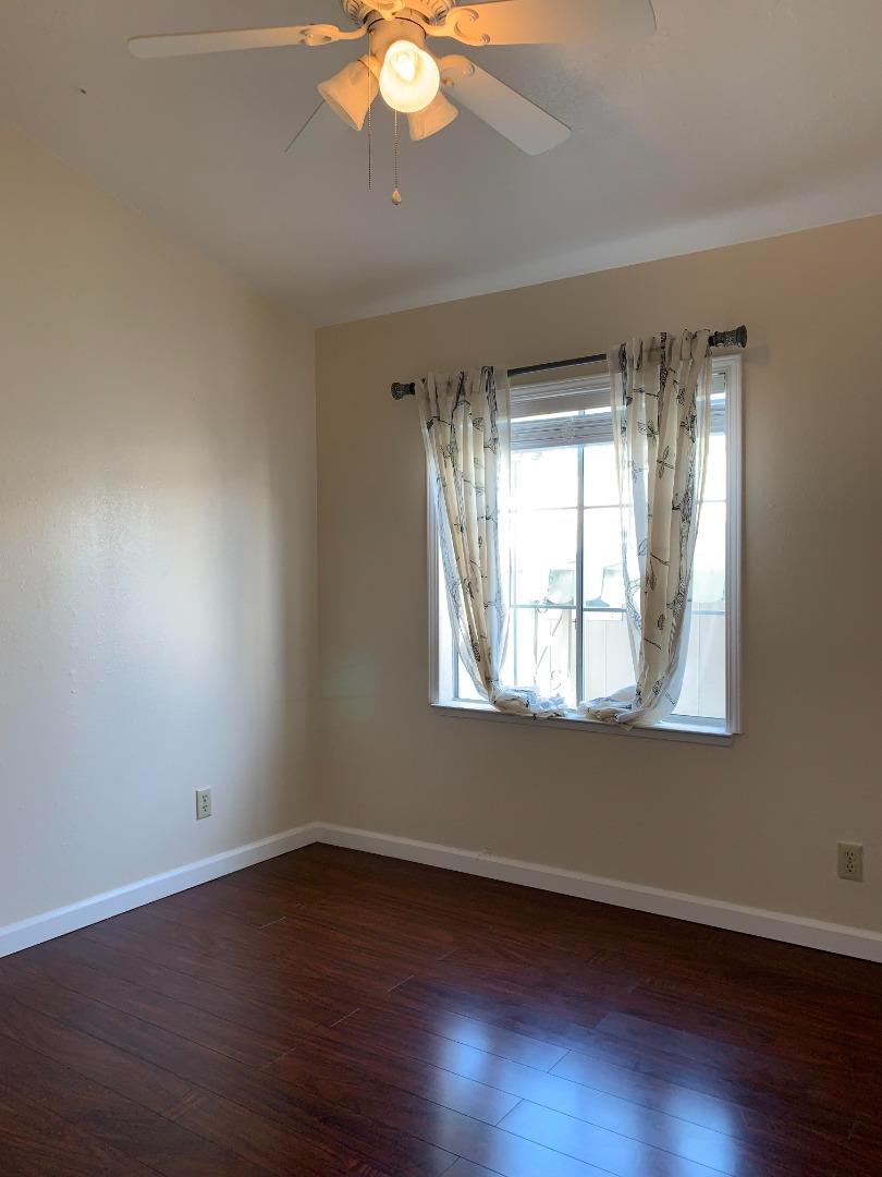 1201 Sycamore Terrace, Unit 87 Sunnyvale, CA 94086 - Photo 7 of 26 an empty room with wooden floor and windows