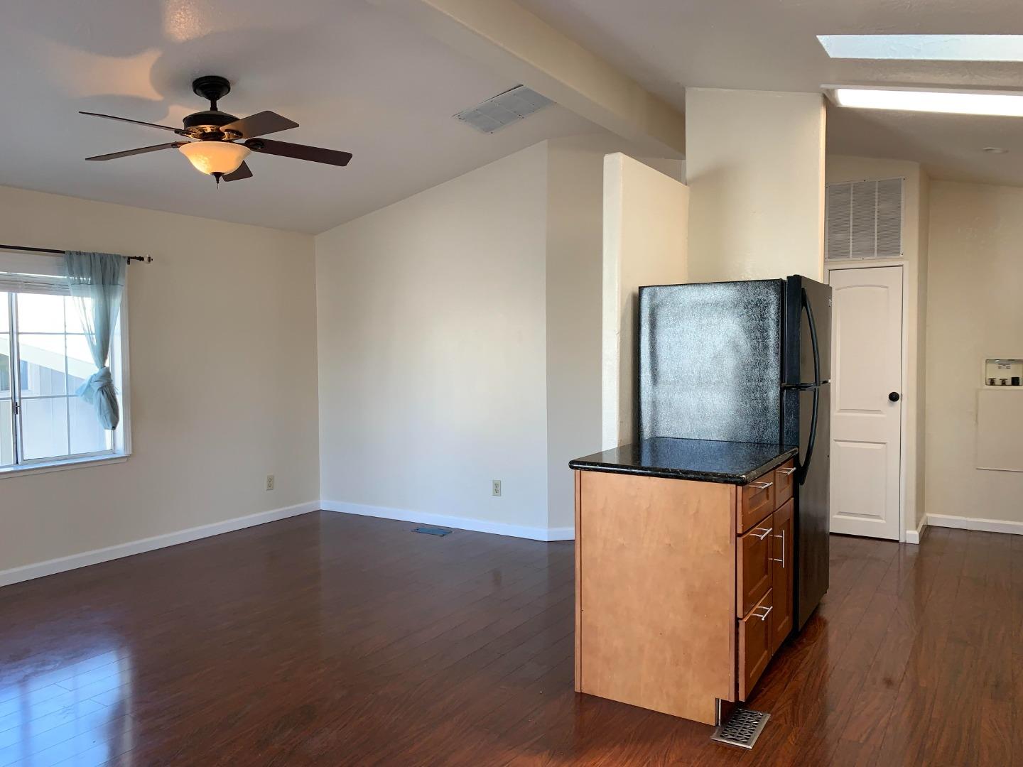 1201 Sycamore Terrace, Unit 87 Sunnyvale, CA 94086 - Photo 8 of 26 a view of a livingroom with wooden floor and a ceiling fan