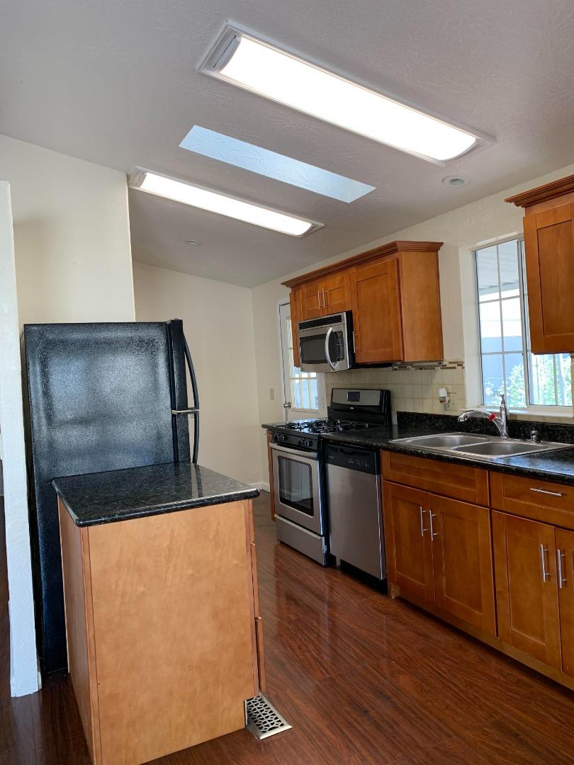 1201 Sycamore Terrace, Unit 87 Sunnyvale, CA 94086 - Photo 10 of 26 a kitchen with stainless steel appliances granite countertop a refrigerator sink and stove