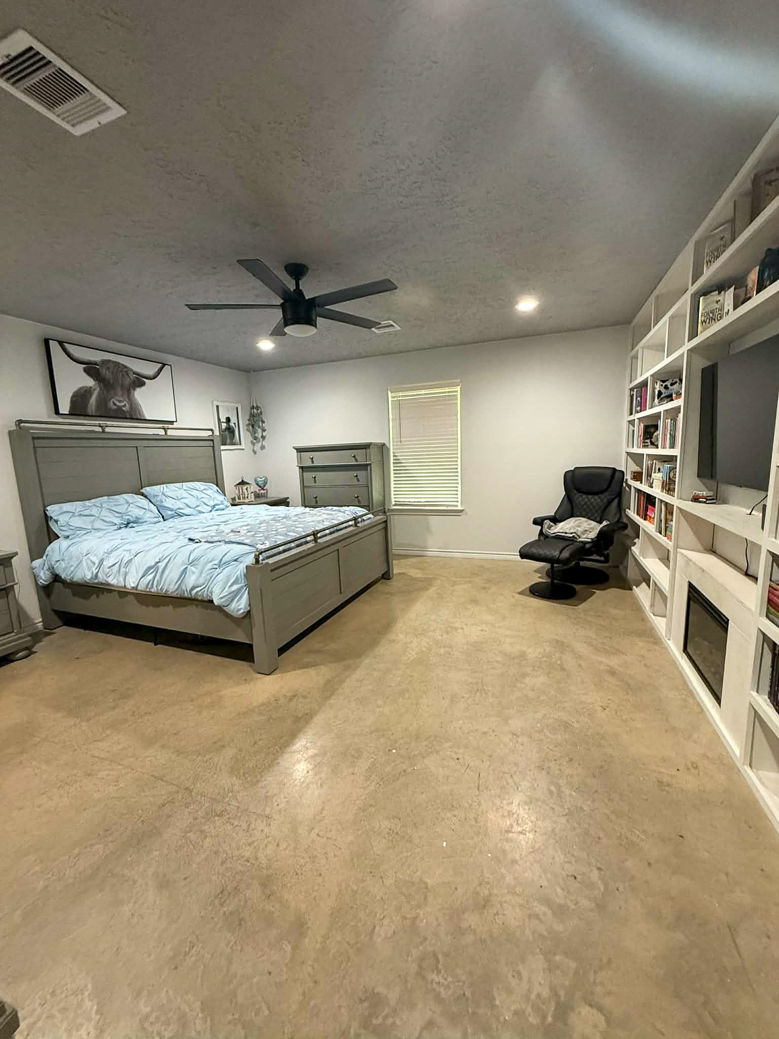 107 County Road 409 Sweeny, TX 77480 - Photo 10 of 20 This spacious bedroom features a modern design with built-in bookshelves. This cozy room features ample natural light, and sleek flooring, offering comfort and practicality.