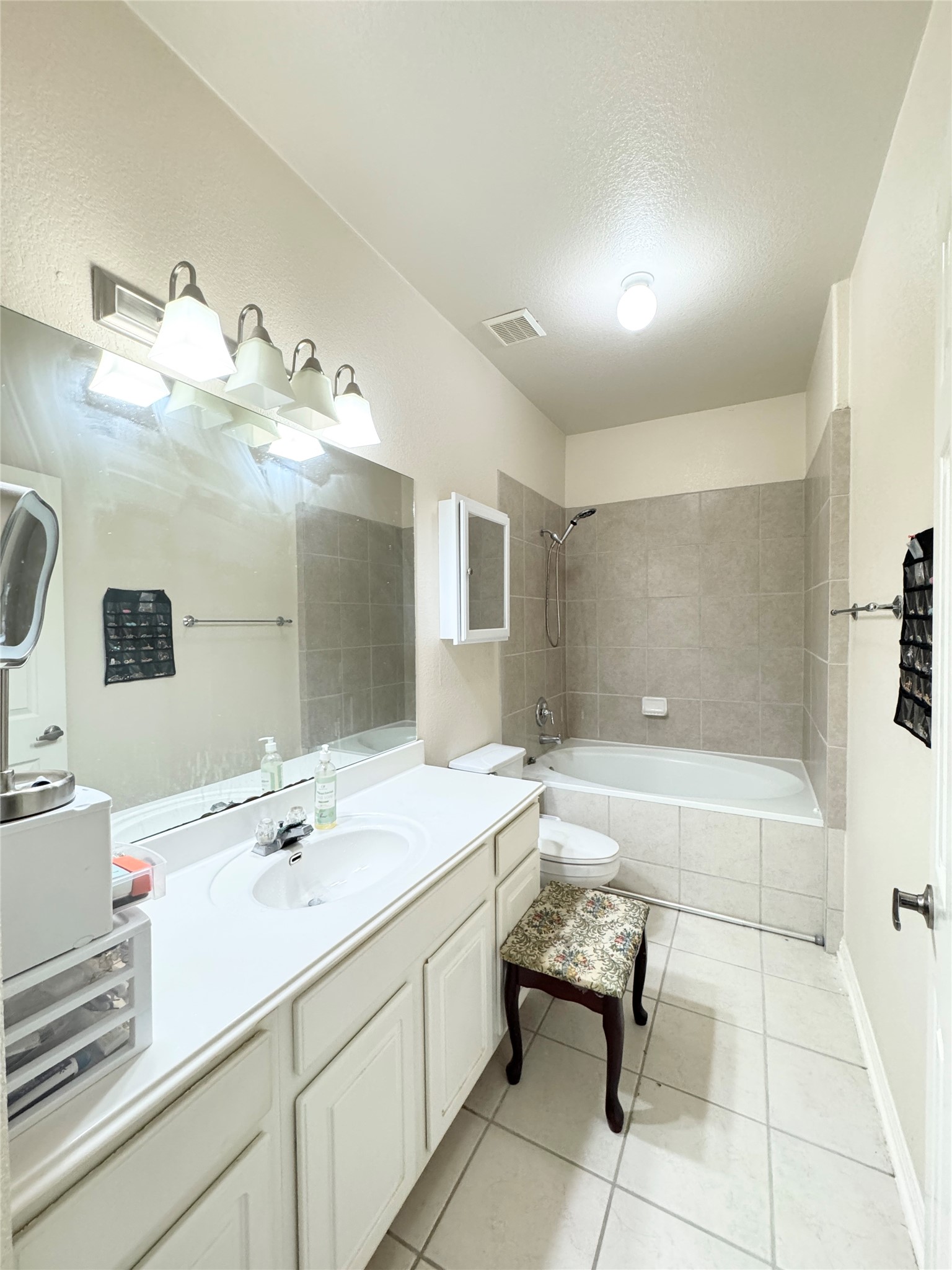 4508 Duval Road, Unit 6602 Austin, TX 78727 - Photo 16 of 23 a bathroom with a tub sink and mirror