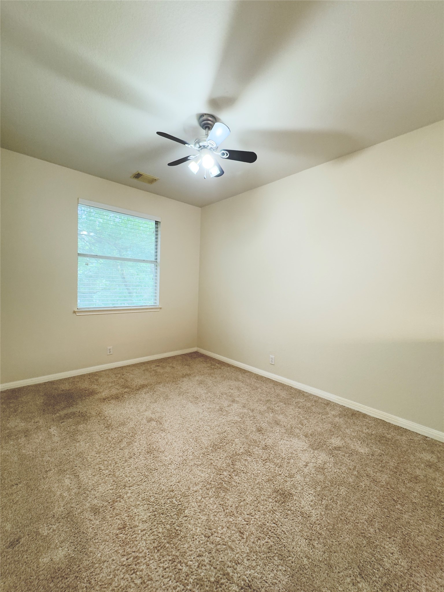 4508 Duval Road, Unit 6602 Austin, TX 78727 - Photo 19 of 23 an empty room with a window and a fan