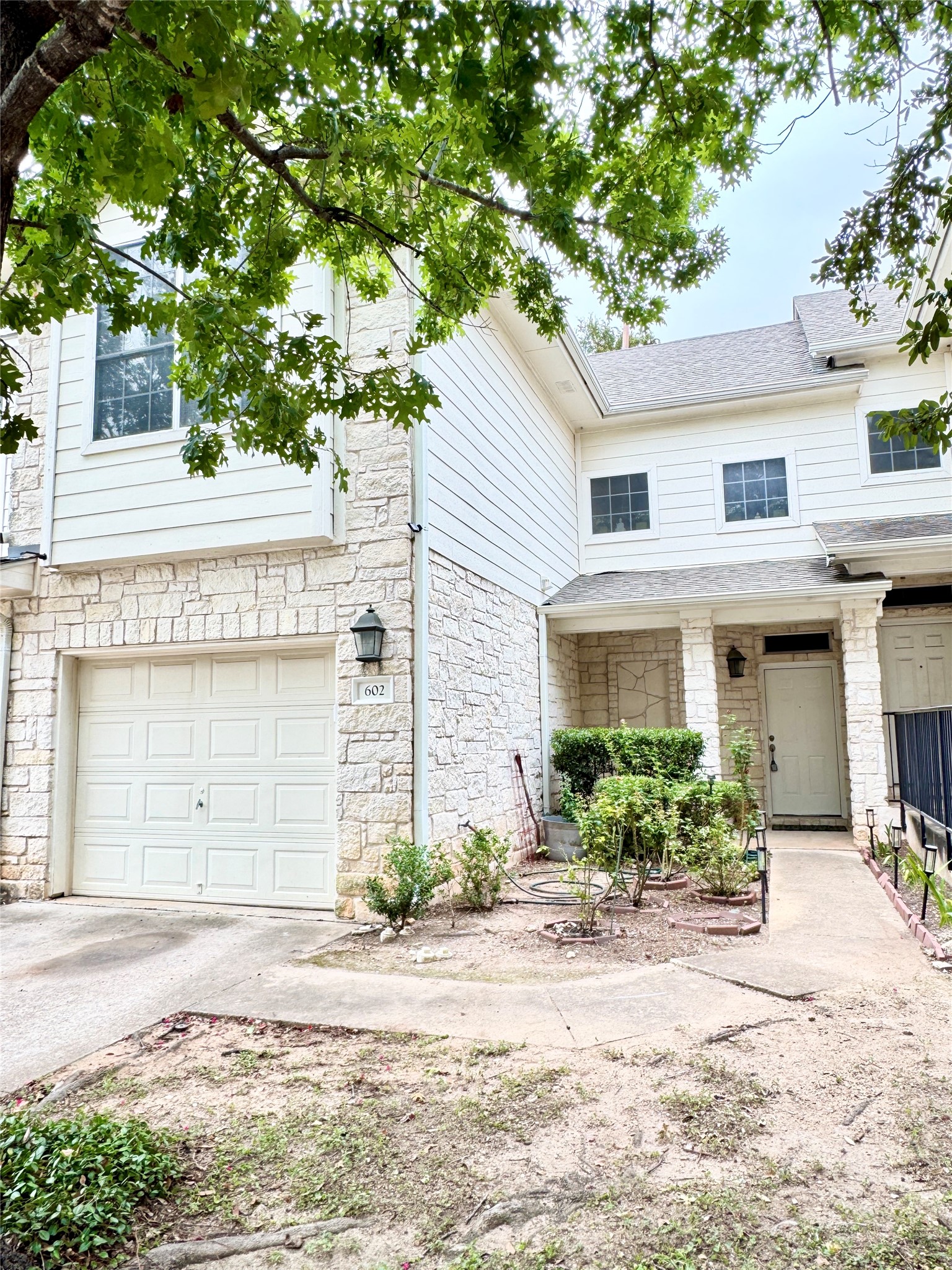 4508 Duval Road, Unit 6602 Austin, TX 78727 - Photo 2 of 23 a front view of a house with a yard and garage