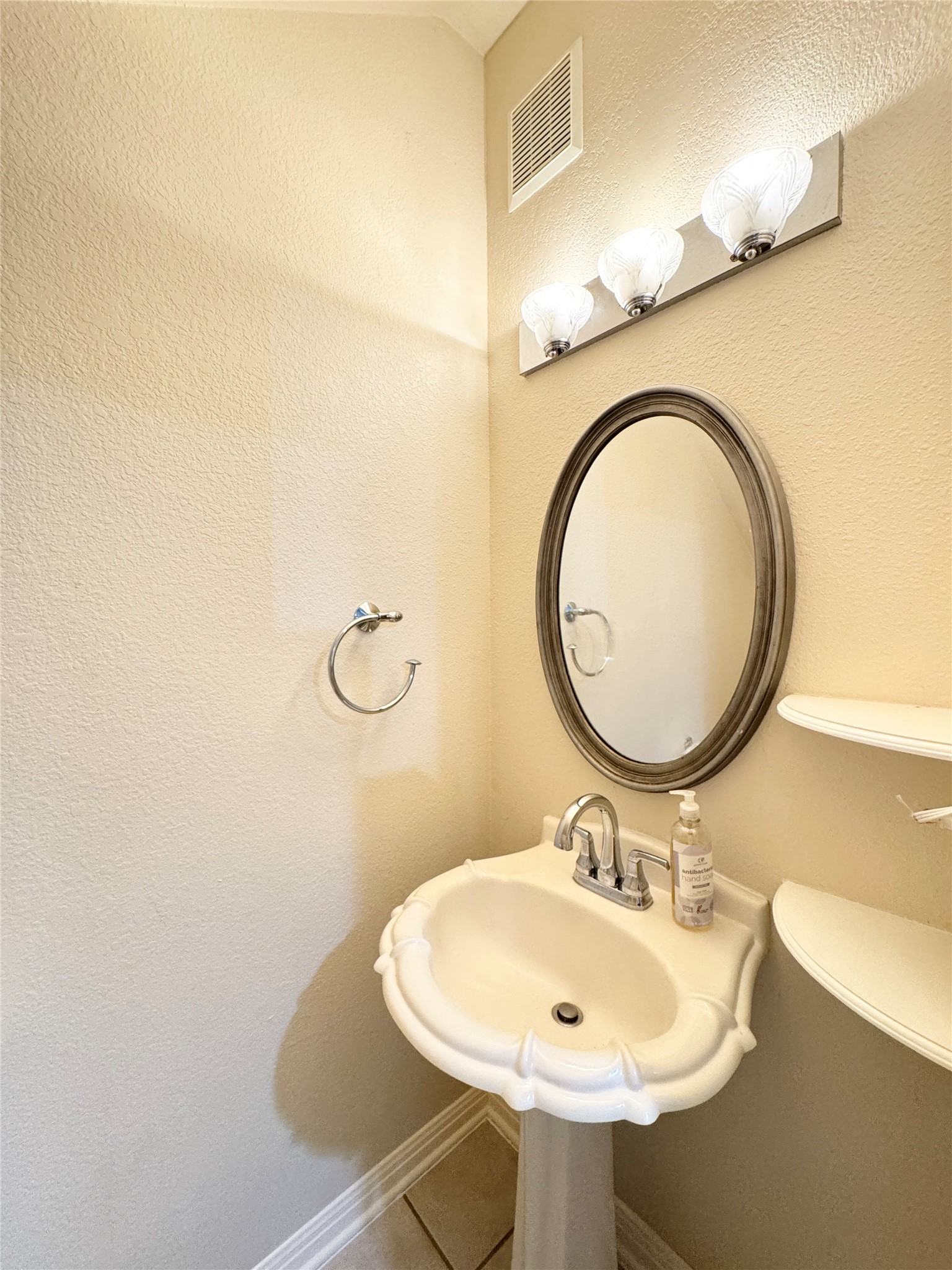 4508 Duval Road, Unit 6602 Austin, TX 78727 - Photo 10 of 23 a bathroom with a sink and a mirror
