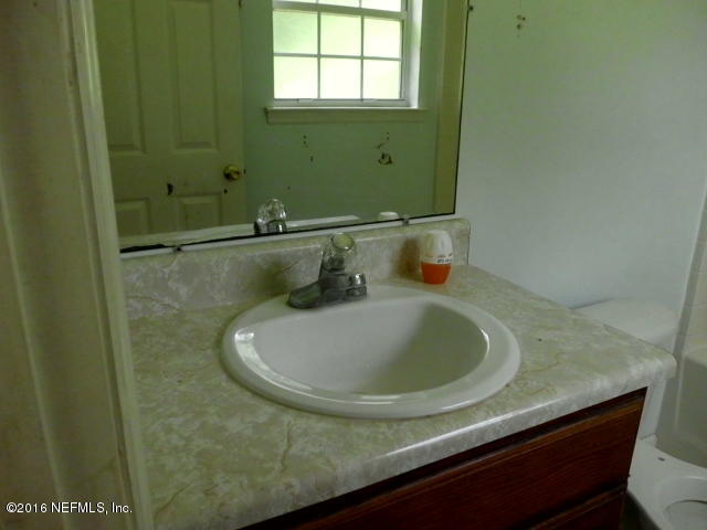 1800 Bennett Road St. Augustine, FL 32092 - Photo 20 of 24 a bathroom with a sink and a mirror