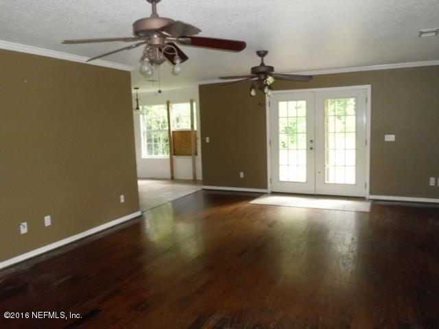 1800 Bennett Road St. Augustine, FL 32092 - Photo 2 of 24 a view of an empty room with a window and wooden floor