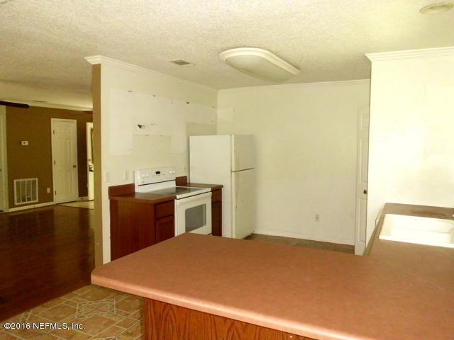 1800 Bennett Road St. Augustine, FL 32092 - Photo 7 of 24 a kitchen with a refrigerator sink and stove