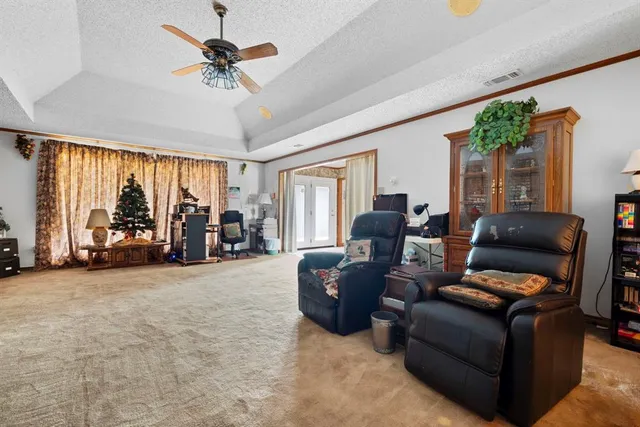 a living room with furniture and a kitchen view