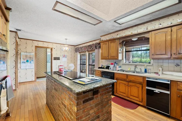 a view of a room with wooden floor and door