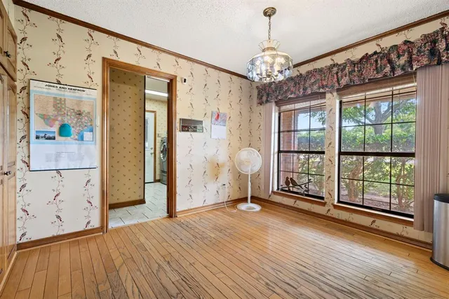 a bedroom with bed and a chandelier