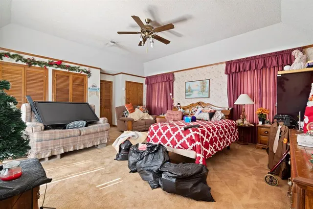 a bedroom with furniture a baby crib and a window