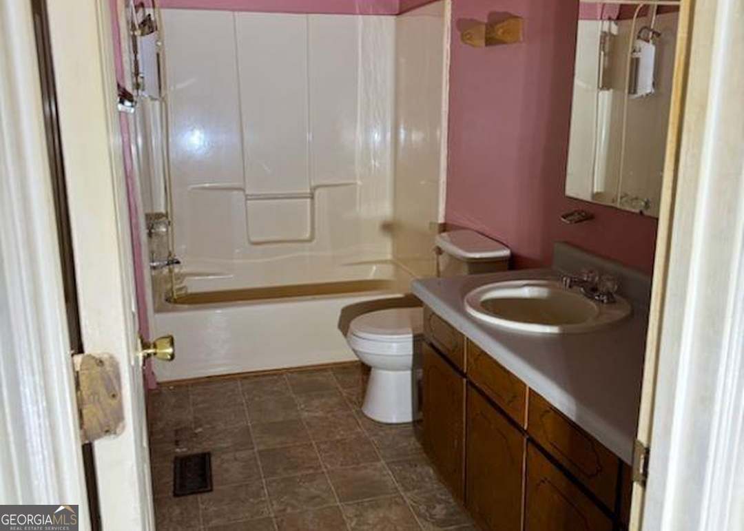 2304 Cummings Road Fort Valley, GA 31030 - Photo 13 of 20 a bathroom with a sink a toilet and shower
