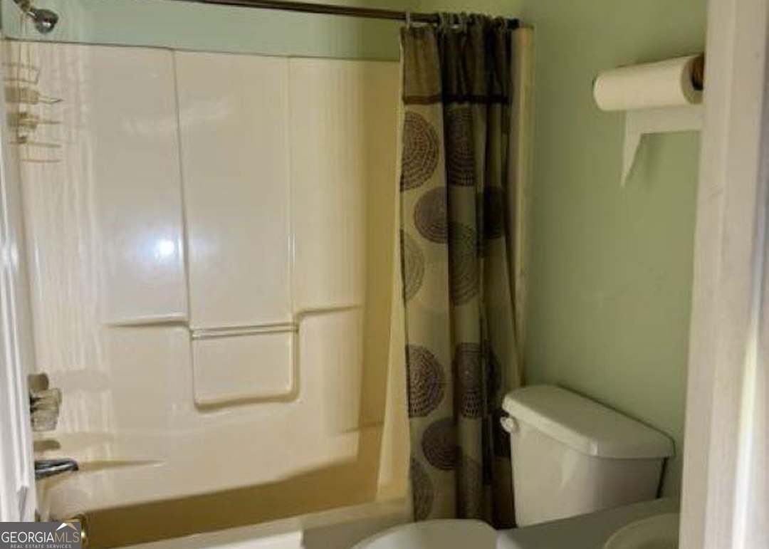 2304 Cummings Road Fort Valley, GA 31030 - Photo 14 of 20 a bathroom with a toilet and a shower