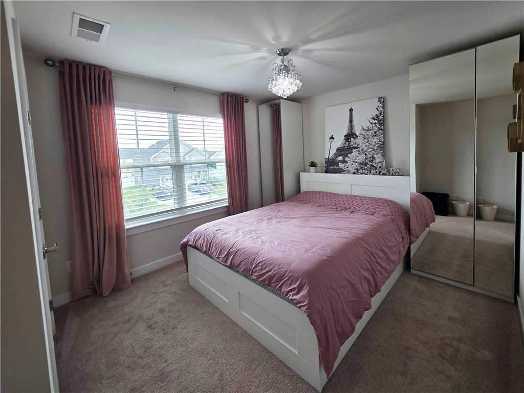 224 Bronson Ridge Anderson, SC 29621 - Photo 20 of 42 A well-lit sleeping area features soft carpet and a clear view through wide windows.