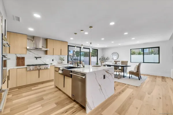 a kitchen with white cabinets stove and sink