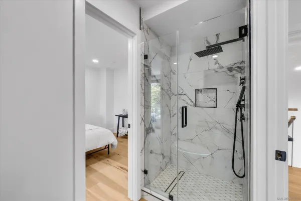 a bathroom with a glass shower door